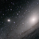 Puny M32 is the fuzzy orb to the left of Andromeda, the bright galaxy.